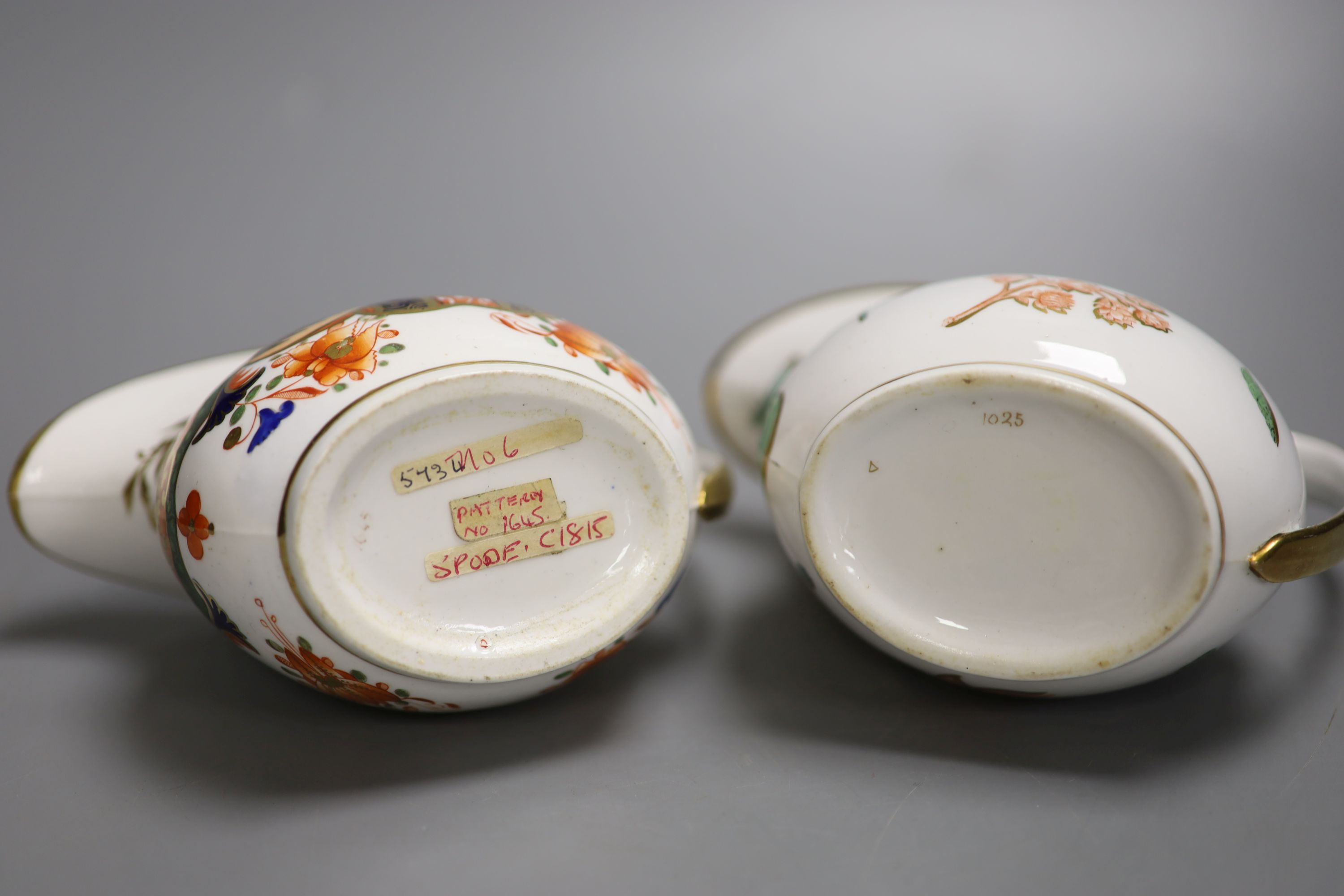 A Spode cream jug painted with Imari pattern 1645 and a Spode cream jug painted with flowers and insects pattern 1025, tallest 10cm